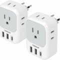 Two white Tessan travel plug adapters with European two-pin plugs, grounded sockets, and multiple USB ports. Each adapter has one three-prong outlet, two USB-A ports, and one USB-C port on the front, designed for versatile power connections and charging devices.